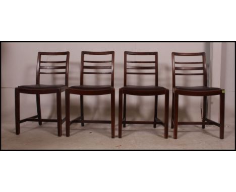 A set of four vintage CC stamped bombed out Britain ladder back dining chairs with drop in seat pads raised on square legs un