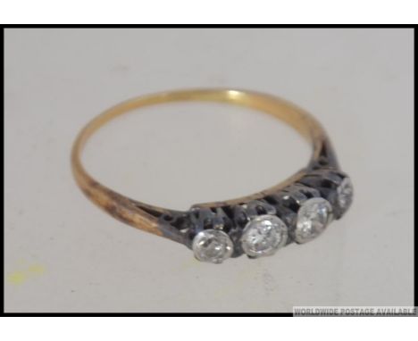 A vintage 18ct gold and 5 stone diamond ring. The diamonds approx 30pnts being claw set, marks rubbed ( tested ) Size K / Wei