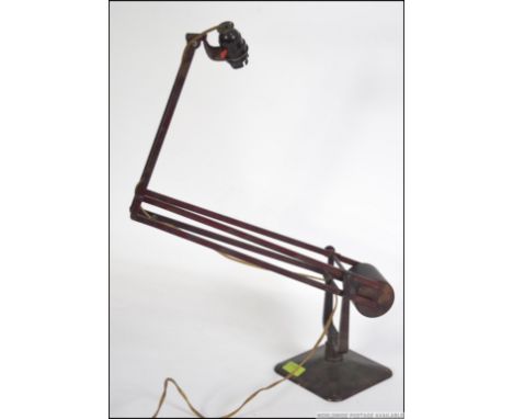 A Hadrill & Horstmann vintage early 20th century anglepoise lamp with squared base, believed original red paint with bakelite