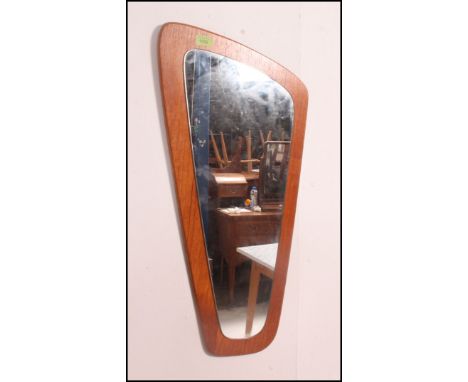 A retro atomic shaped teak wood frameless wall mirror. The teak panel with applied mirror