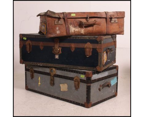 A good collection of three travel cases ,, 1 leather suitcase and two steamer trunks, one complete with interior shelf . Many