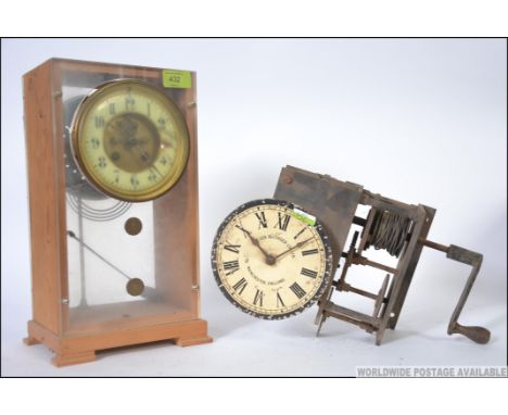 A vintage ' The Lea Recorder Co Ltd ' clock movement along with a Victorian eight day movement having an enamel chapter ring 