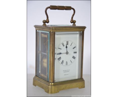 A 20th century French made brass carriage clock, enamel dial with Roman numerals and retailers name for Walter Wyatt Bournemo