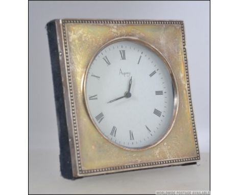 A 20th century silver hallmarked desk clock having a roman numeral  chapter ring and Asprey to the face, having a London assa