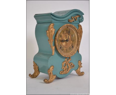 A 19th century painted metal and gilt embellished mantel clock by Ansonia clock co. Brass 8 day movement set within. Measure: