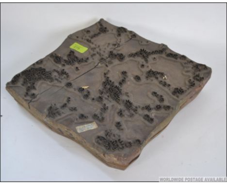 An unusual 1930's wooden step printers block. Applied inset metal shapes - footprints, lillies, water etc. The verso with not