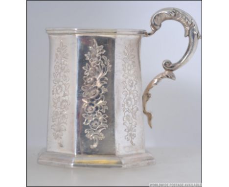 A 19th century silver hallmarked tankard by Thomas Edwards bearing London hallmarks for 1846. Chase decorated with rococo scr