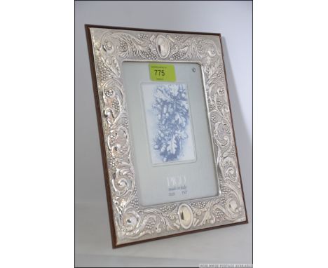 A silver hallmarked picture frame in the rococo style with glass panel centre and easel back. Stamped 925 to corner. Weight a