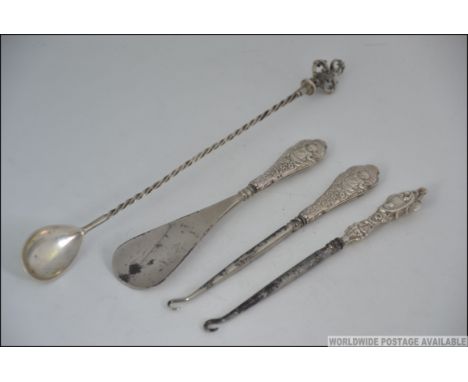 A silver large twizzle spoon with crown top, weight 40g together with 2 silver handled button hooks and a silver handled shoe