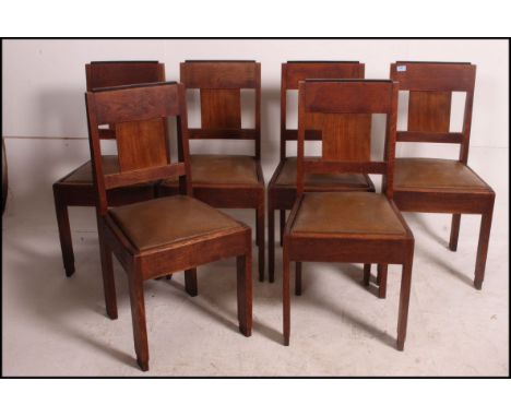 A good set of 6 heavy oak 1930's Art Deco dining chairs raised on squared legs with drop in seats and panel back rests. Measu