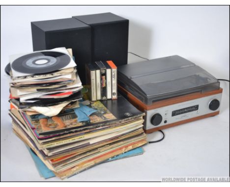 A collection of vinyl Long Play and 45rpm single records dating from the 1960's through to the 1980's along with a record pla