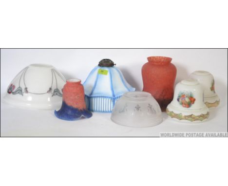 A collection of seven vintage glass light shades of varying designs and colours please see images. Measures: 20cms high.