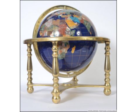 A large floor standing / table top semi-precious stone inlaid terrestrial globe of the world, raised on a gilt metal gimble b