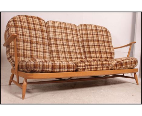 A Ercol Windsor pattern 1970's 3 seat sofa settee in beech and elm. The sofa retaining the original wool upholstered cushions