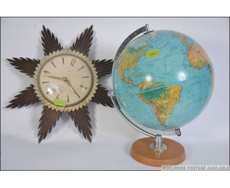 A retro 20th century desk top globe on swivel and plinth together with a mid century Metamec sunburst clock. Measure: 41cms h