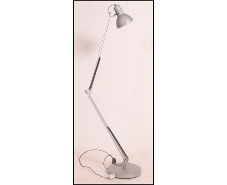 A 20th century contemporary floor standing anglepoise style lamp being raised on a circular mounted base and finished with a 