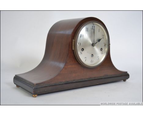 A 1930's napoleons hat mantel clock with silvered dial, roman numeral chapter ring having inset Westminster chiming Junghans 