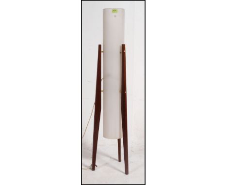 A 1960's vintage teak rocket lamp raised on angled supports with white tall cylinder shade. Measure: 116cms high.