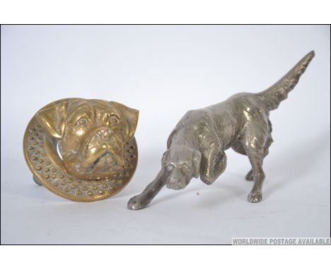 A silver white metal figurine of a hunting dog along with a brass door knocker in the form of a dog with NVB to verso. L21cm