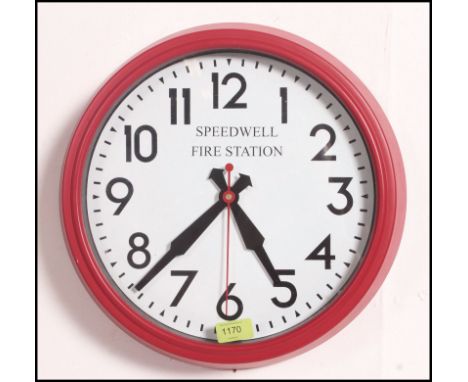 A retro wall hanging clock with a fire engine red case having notation to the face for Speedwell Fire station. Measure: 39cms