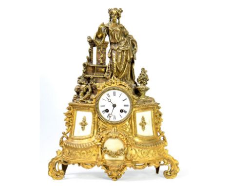 AN ORNATE FRENCH BRASS MANTEL CLOCK, THE SWEPT CASE SURMOUNTED BY THE FIGURE OF A LADY, THE MOVEMENT WITH ENAMEL DIAL AND STR