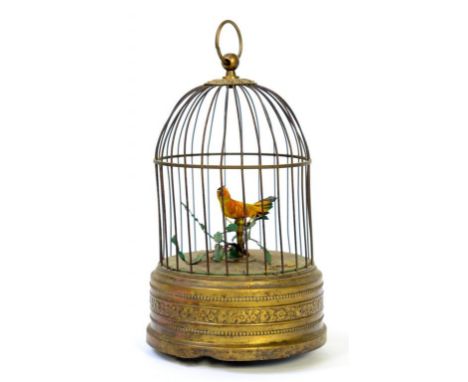 AN EMBOSSED BRASS AND CLOCKWORK SINGING BIRD IN A CAGE AUTOMATON, 23CM H, 20TH C 
