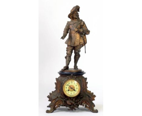 A FRENCH SPELTER GILT FIGURAL MANTEL CLOCK IN THE FORM OF A CAVALIER, ON PLINTH, THE LEAFY SCROLLING BASE INSET WITH BRASS AN