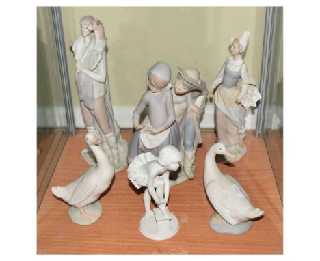 Three Lladro figures, together with examples by Nao and Kaiser, 28cm high and smaller