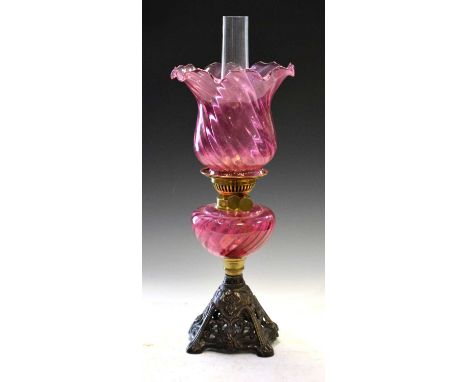 Art Nouveau-style cranberry oil lamp, the metal base cast with tendril decoration, 55cm high