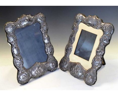 Pair of Elizabeth II silver easel photograph frames, the border with embossed 'Reynolds Angels' and scroll decoration, Birmin
