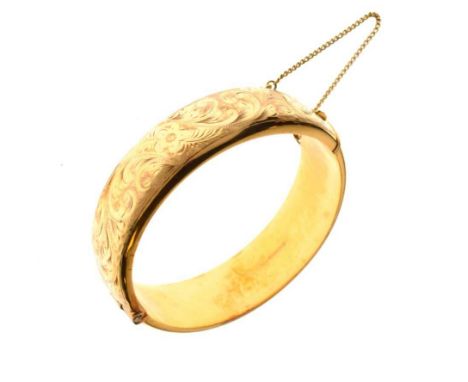 9ct gold half engraved hinged bangle, Birmingham 1962, approximately 18mm wide, internal diameter 6cm, 29g gross approx