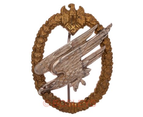 German Third Reich WW2 Army Parachutist’s breast badge.A good scarce die-cast lightweight example. Mounted on a gilt oval oak