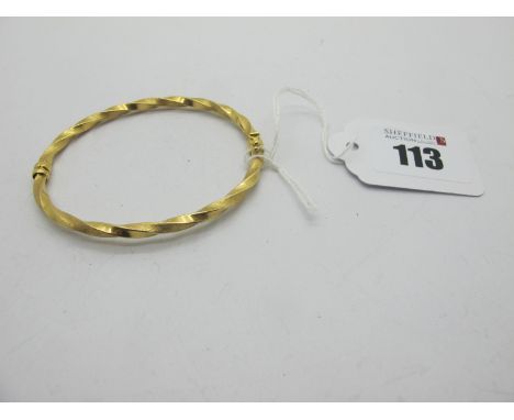 A Modern Twist Style Bangle, with alternate brushed finish detail, stamped "750" (5.5 grams).