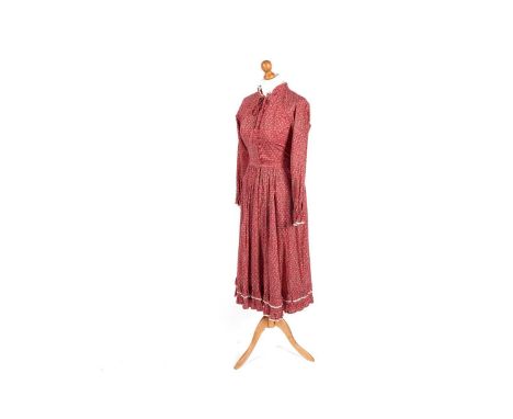 A 1970s Origin prairie dress in Liberty of London printed cotton, with flounced neck, button-down bodice, long sleeves with f