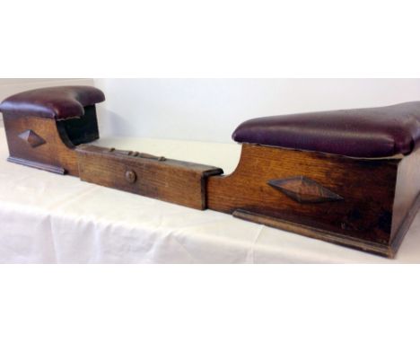 A c1930s extending wooden fire fender with leather padded corners.