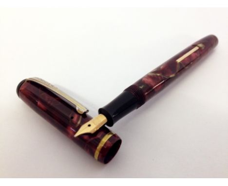 Burnham B44 Fountain Pen c1940s.Pink and gold veined marble with rolled gold trim. A lever fille,r pocket clip carries ?Burnh