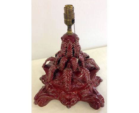 An antique continental majolica table lamp in red glaze, approx 33cm tall.