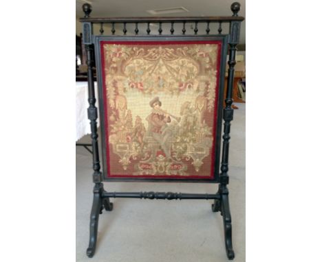 A large Victorian tapestry fire screen with turned wood supports and stretcher, and galleried top.