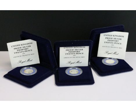 A collection of three Royal Mint United Kingdom silver proof 20p coins to include Piedfort, all encapsulated within fitted di