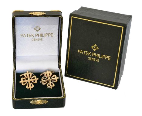 A pair of Patek Philippe gold plated cufflinks, each designed with the maker's logo, with hinged bar fittings, signed Patek P