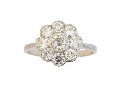 A diamond cluster ring, the old cut diamond within a circular cut diamond scalloped surround, estimated total diamond weight 