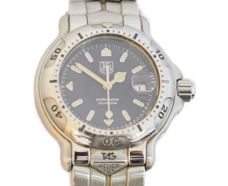 A ladies stainless steel Tag Heuer watch, ref. WH 1315-K1, the navy blue signed dial with luminescent baton hour markers, dat