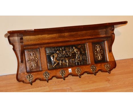 An oak hanging wall shelf, with six fitted hat and coat hooks, 38cm high x 92cm wide