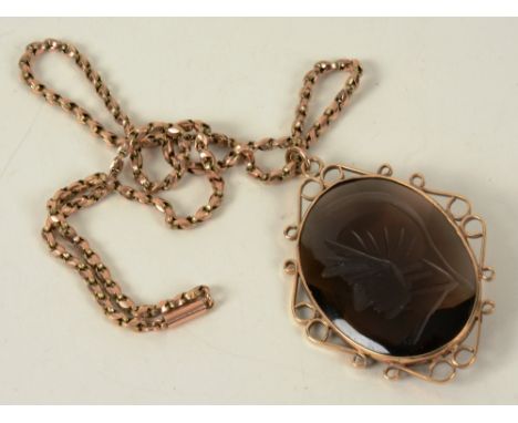 A yellow metal and smoky quartz pendant, the large round quartz etched with warrior portrait, on 9ct gold chain, chain 6.5g, 