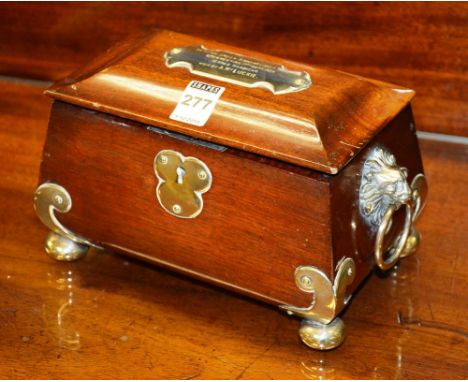 A mahogany tea caddy, with presentation plated mount and lion mask ring handles, 13 x 21cm