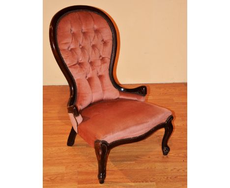A Victorian style spoon back nursing chair, upholstered in pink button back, 85cm high x 58cm wide