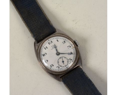 A vintage Omega boys white metal cased wristwatch circa 1960's, the circular white enamel dial with Arabic numerals and subsi