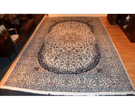 A large Persian Nain carpet, decorated with floral motifs on cream ground, 520cm long x 343cm wide CONDITION REPORT: Lot 371 