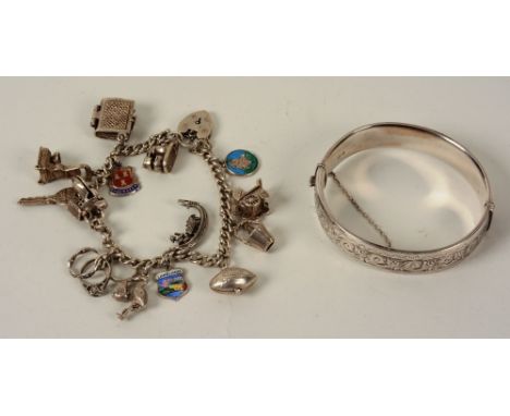 A silver charm bracelet, together with a Sterling silver bangle with foliate etched decoration to top (2)