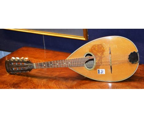 A bow back mandolin, with plated mount and plectrum, 65cm long